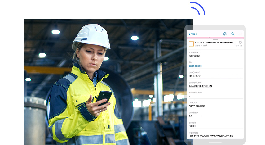 A person in a white hard hat and yellow safety jacket looking at a mobile phone held in their hand, beside a large graphic of a phone screen displaying a fictional person's account data,A person in a white hard hat and yellow safety jacket looking at a mobile phone held in their hand, beside a large graphic of a phone screen displaying a fictional person's account data