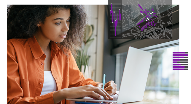 Young woman with orange top working on a laptop computer with a small image of a street map,Young woman with orange top working on a laptop computer with a small image of a street map