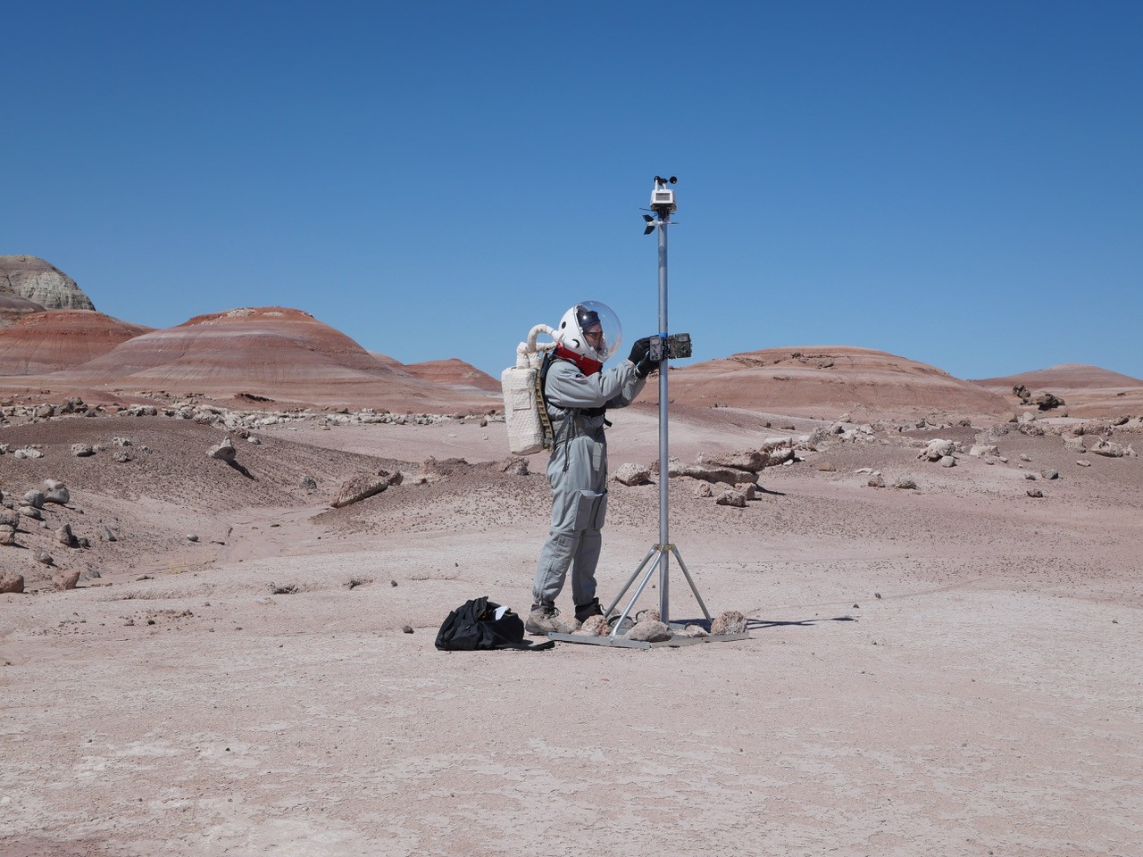 Two people workin in the field looking at the camera.