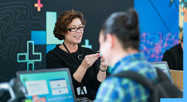 Woman helping attendees at the Esri User Conference