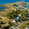 An aerial view of a neighborhood along a lake