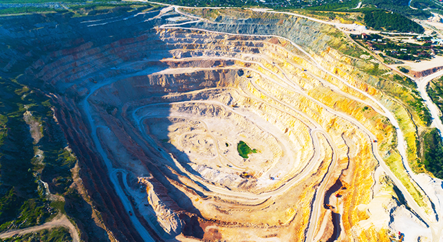 A landscape used for mining in the past now turning green with trees and grass