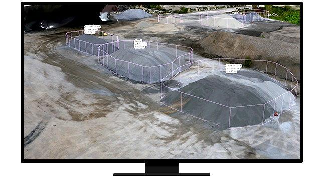 A desktop computer screen showing three stockpiles of gravel surrounded by pink 3D lines showing width and height and calculations hovering of the piles showing the resource volumes 