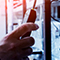 Closeup photo of a hand holding a chemical detector with a blurry blue and white background