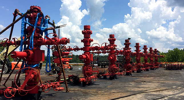 A photo of a concrete lot full of utility equipment under a cloudy blue sky