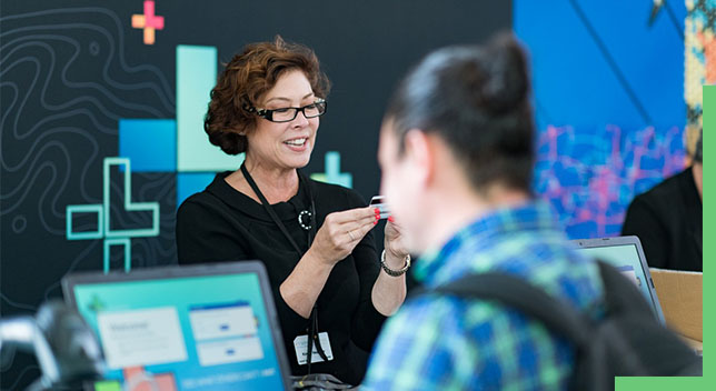 woman at a conference registration desk