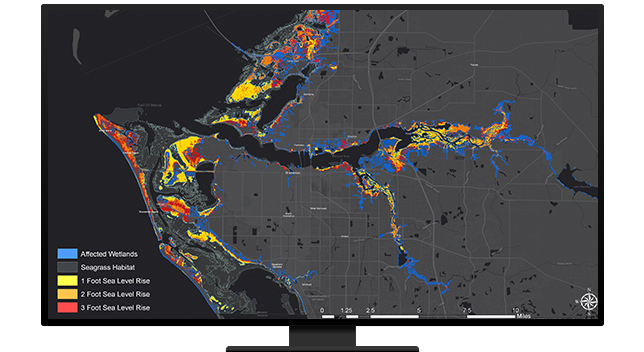 A desktop computer showing a map with highlighted areas that were affected by floods and other watershed