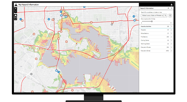 A desktop computer showing a map of hazard information with red lines indicated traffic areas, red dots showing collisions, and other locations marked for important destinations such as hospitals and shelter locations