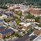 An aerial view of a bustling city full of brick buildings and tree-lined streets