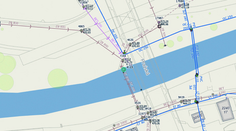 A utility asset map bisected by a river displaying the locations of different service lines 