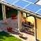 A yellow house with solar panels on the roof