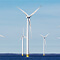 Wind turbines built on concrete stands sticking out of the ocean