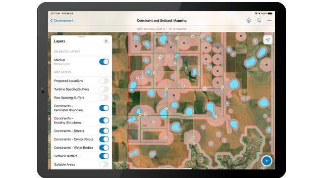 A tablet displaying a field map with bright blue areas indicating water